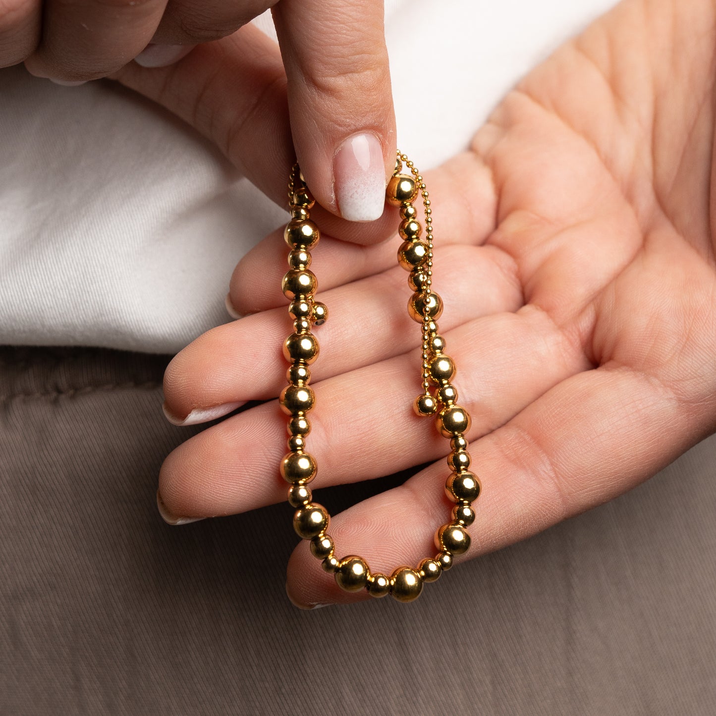 Pulsera esferas bañado en oro