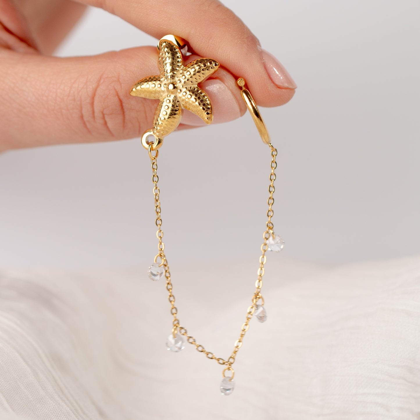 Aro ear cuff estrella de mar cadena bañado en oro