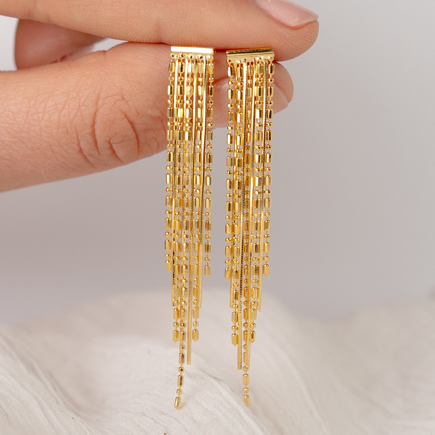 Aros colgantes palitos bañado en oro