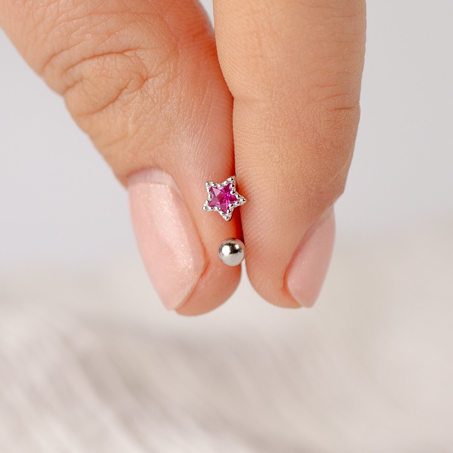 Aros pegados estrella fucsia cierre pelotita