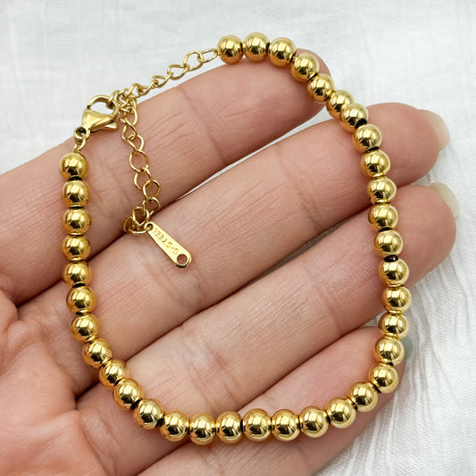 Pulseras esferas bañado en oro